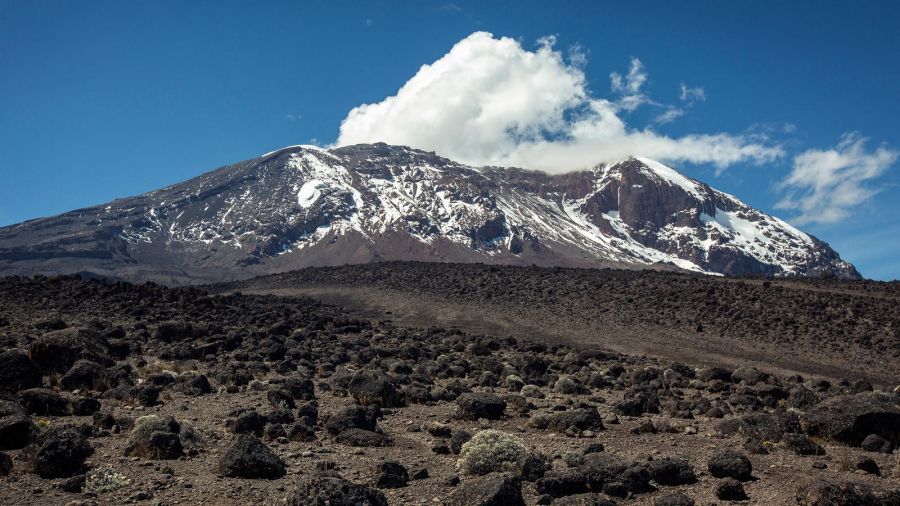 Mount Kilimanjaro with blue sky and clouds.