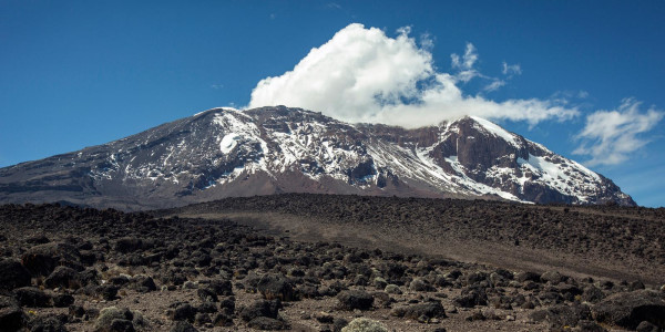 Mount Kilimanjaro with blue sky and clouds.