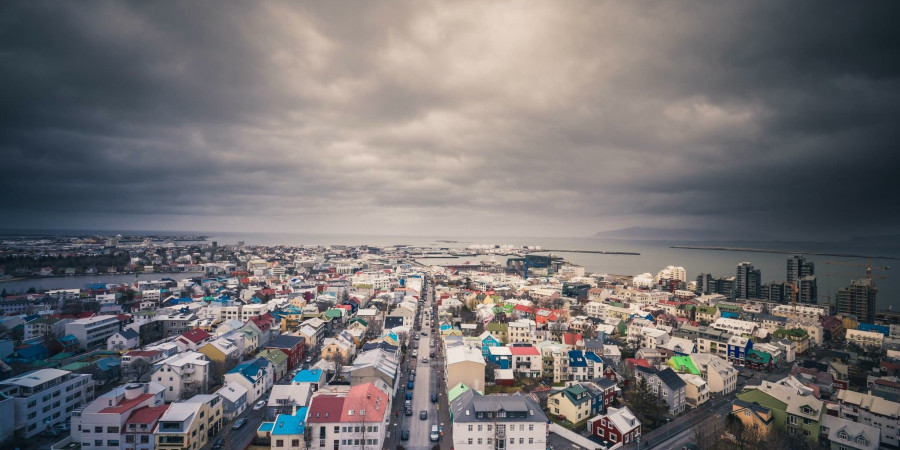 Wide view of Reykjavik with stormy clouds.