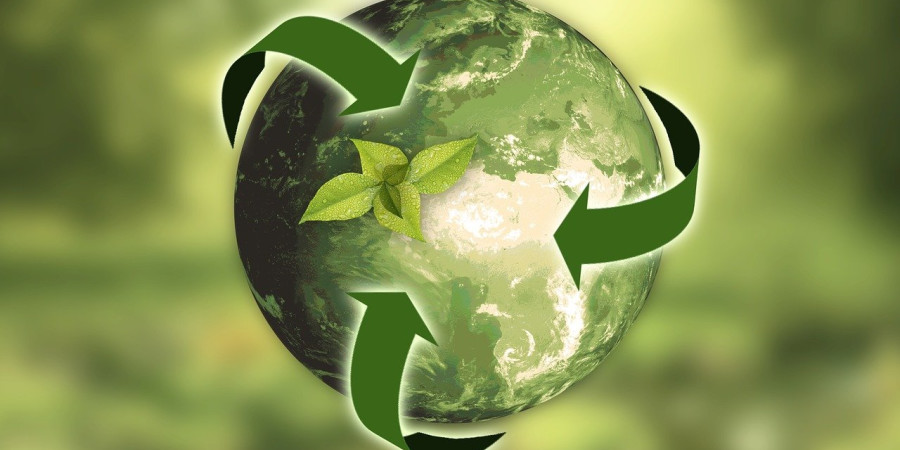 Recycling symbol over the planet.