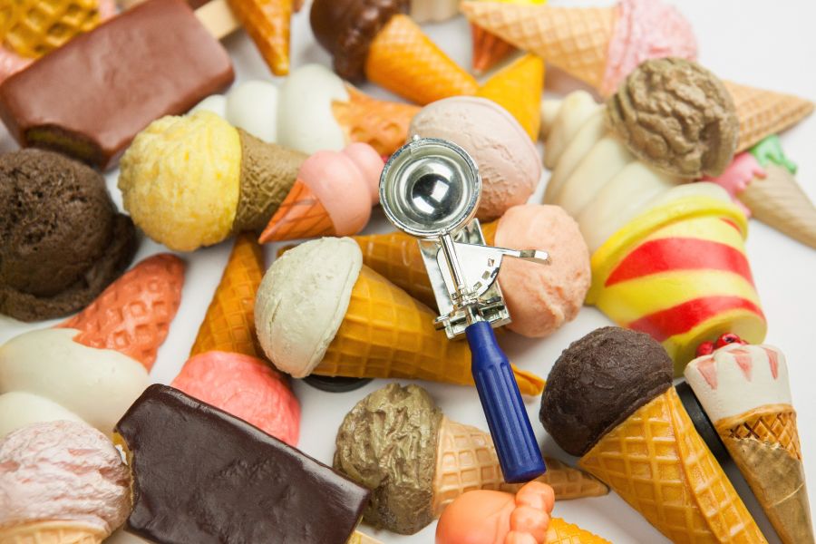 selection of ice cream cones and a scoop.